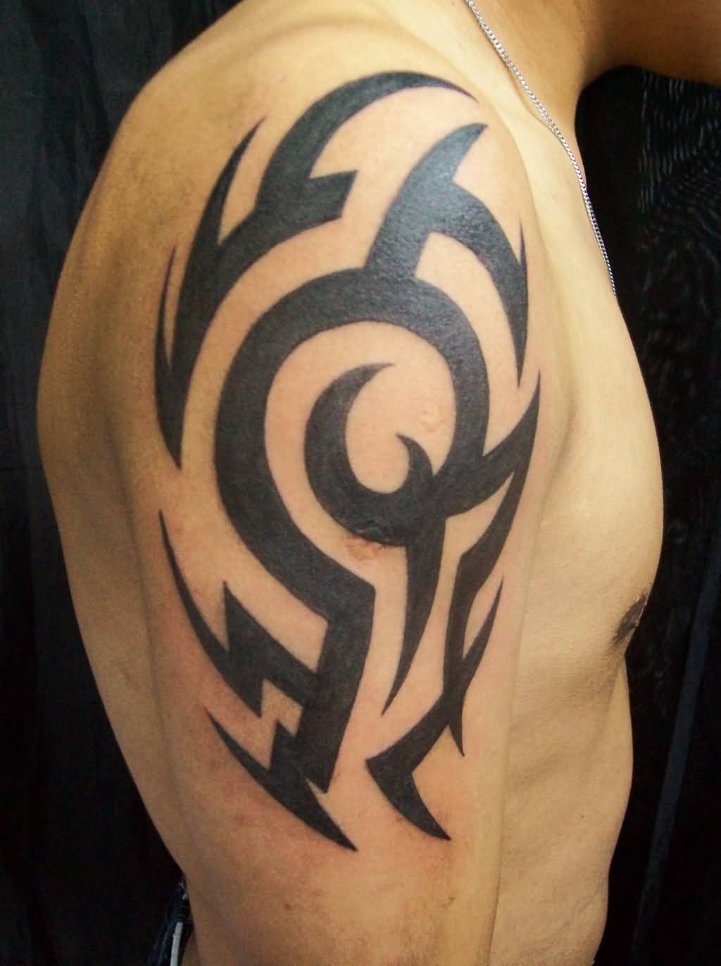 Black Ink Famous Tribal Tattoo On Upper Arm For Guys ...