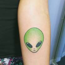Beautiful Alien Head Tattoo On Sleeve Made With Green Ink