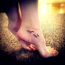 Black Ink Flying Birds Tattoo On Girl Ankle