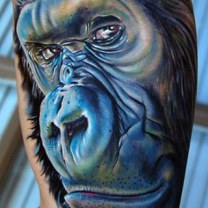 Blue Ink Amazing Monkey Animal Face Tattoo On Biceps
