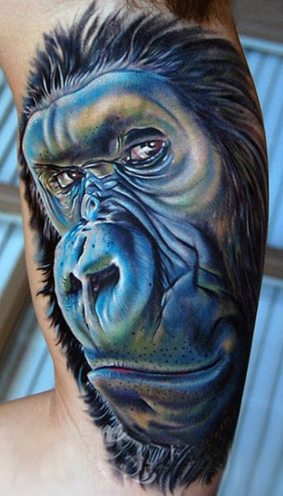 Blue Ink Amazing Monkey Animal Face Tattoo On Biceps